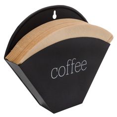 a coffee cup holder with the word coffee in white lettering on black paper and wood