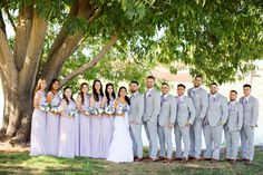 a group of people standing next to each other under a tree