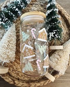 a glass jar with christmas decorations on it