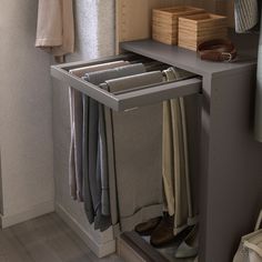 an open closet with folded clothes and shoes