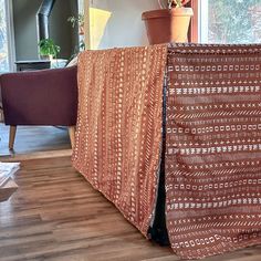 a living room with a couch covered in a blanket