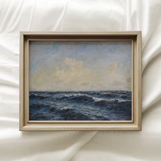 a painting hanging on the wall above a bed