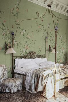 a bed sitting in a bedroom next to two lamps