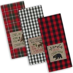 three red and black plaid kitchen towels with moose, owl, and christmas designs on them