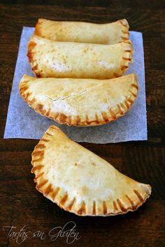 three pastries sitting on top of a piece of wax paper next to each other