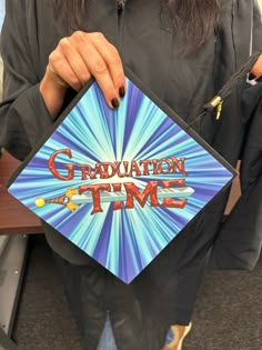 a person holding up a sign that says graduation time