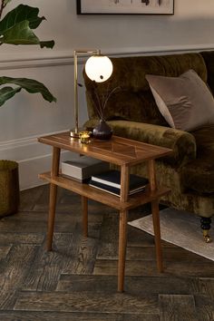 a living room scene with focus on the end table and lamp in the centerpiece