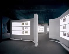 an empty room with multiple displays on the wall