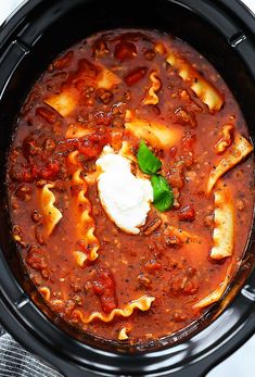 a slow cooker filled with pasta and sauce