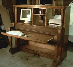 an old wooden desk with a computer on it