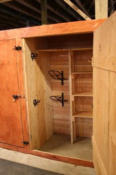 a large wooden cabinet sitting inside of a building with lots of shelves and doors on each side