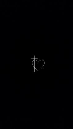 a heart with a cross drawn on it in the middle of black night sky,