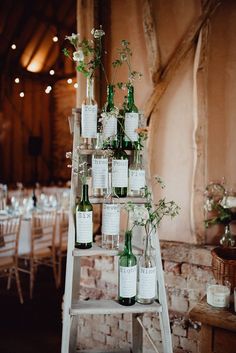 the table is set up with wine bottles and flowers