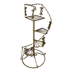 a metal stand with three tiers and four baskets on it's sides, in the shape of a spiral staircase