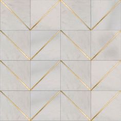 a white tile wall with gold lines on it