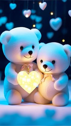 two white teddy bears holding a heart shaped light in front of some blue and white hearts