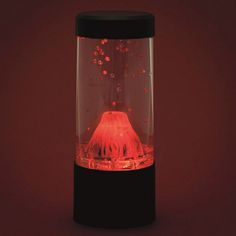 a red light in a glass container on a black base with water and bubbles around it