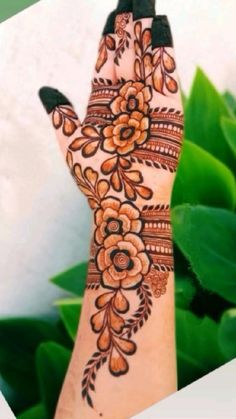 a woman's hand with henna on it