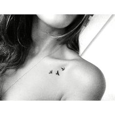 a woman's chest with three birds on it