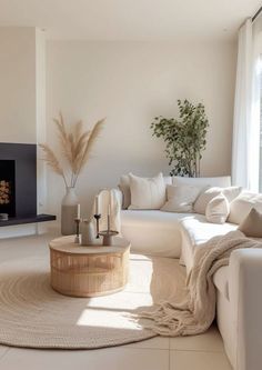 a living room with white furniture and a fire place