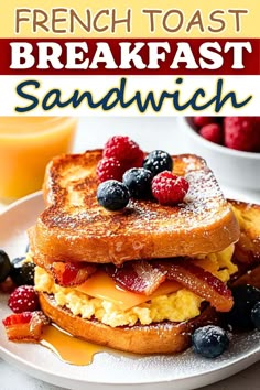 french toast breakfast sandwich on a white plate with berries and orange juice in the background