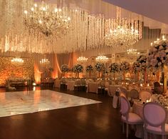 an elegant ballroom with chandeliers and tables set up for a formal function or wedding