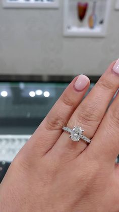 a woman's hand with two engagement rings on it