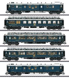 four blue train cars sitting side by side on the same track as one car in different positions