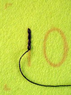 a close up of a piece of cloth with writing on it and a cord in the middle