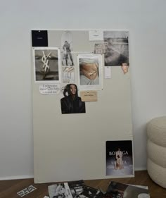 a refrigerator covered in pictures and magnets next to a white wall with books on it