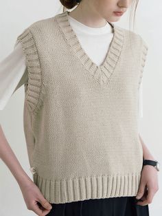 Editor's NotesThis vest is made of cotton and acrylic. It features a minimal design with a casual mood. It is great to style in various ways creating comfortable and trendy wear. Wear this item alone or with a basic design shirt. - Wide ribbed detail knit vest- V-neck and a relaxed fit- Ribbed hem detail and a must-have item - Daily and stylish item Measurements (inch)One size (XS-M)- Shoulder: 17.32 in. - Chest: 19.68 in.- Armhole: 8.26 in. - Hem: 15.94 in. - Lengt Cotton Sleeveless Sweater Vest For Layering, Beige Cotton Sweater Vest For Winter, Relaxed Fit Cotton Casual Vest, Casual Cotton Relaxed Fit Vest, Casual Beige Cotton Sweater Vest, Casual Cotton Sweater Vest With Relaxed Fit, Sleeveless Cotton Sweater For Layering, Trendy Sleeveless Cotton Sweater, Cotton Vest Sweater For Layering