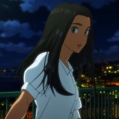 a woman with long black hair standing in front of a city at night