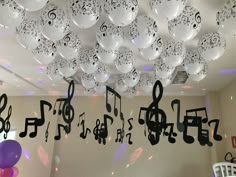 balloons and musical notes are hanging from the ceiling