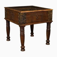 an old wooden table with carvings on the top and legs, against a white background