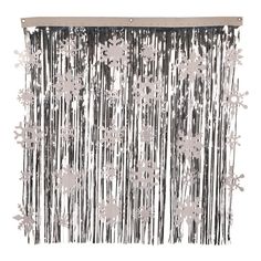 a curtain with silver foil flowers hanging from it's side and fringes on the bottom