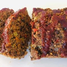 two slices of meatloaf sitting next to each other on a white table top