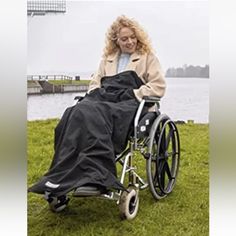 a woman sitting in a wheel chair on the grass