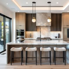 a kitchen with marble counter tops and bar stools