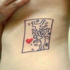 a woman's stomach with a tattoo on it that has a drawing of a man holding a heart