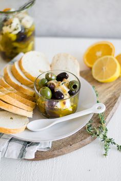 olives and bread are served on a plate