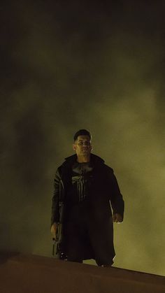 a man standing on top of a roof in the dark