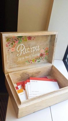 a wooden box filled with cards and envelopes