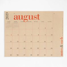 an orange and white calendar with the word august on it's front cover is shown