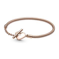 Add a warm-toned accent to your look with the Pandora Moments Heart T-Bar Snake Chain Bracelet. Hand-finished in 14k rose gold-plated unique metal blend, this piece is an updated take on the Pandora Moments snake chain bracelet. Featuring a heart-shaped T-bar double circle closure, loop the T-bar through the smallest circle to guarantee that the bracelet clasp is securely closed. Wear this sleek, modern style with up to 10-13 Pandora Moments charms and dangles. This bracelet measures 6.3inches. Pandora Heart, Rose Gold Charms, Snake Chain Bracelets, Bracelet Charms, Gold Charm Bracelet, Rose Style, Bar Bracelets, Pandora Bracelets, Heart Locket