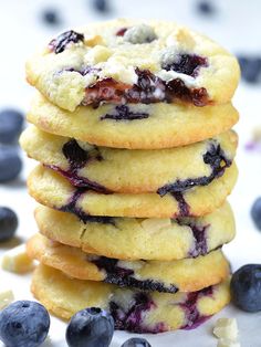 a stack of blueberry cookies sitting on top of a white plate