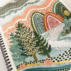 a drawing book with an image of trees and mountains