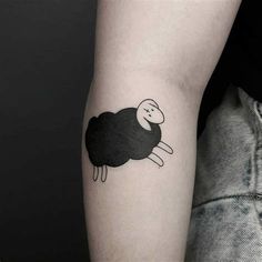 a black and white sheep tattoo on the arm