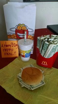 a mcdonald's happy birthday burger and some money