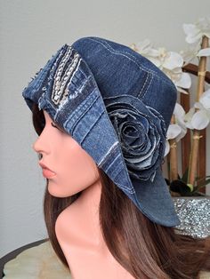 a woman's hat with a flower on it sitting on top of a mannequin head