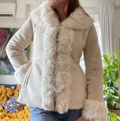 Elevate your style with our collection of Women's Penny Lane Coats and Jackets, inspired by the iconic Boho Hippie fashion of the 90s. Crafted with premium materials like fur, shearling, wool, and suede leather, our Penny Lane designs offer timeless elegance and cozy warmth. From the classic short body Afghan coat to the chic white variations, our range caters to every preference. Embrace the spirit of vintage fashion with our versatile selection, perfect for adding a touch of retro charm to any Short Afghan Coat, Cold Weather Leather Jacket With Faux Fur Trim, Long Sleeve Faux Fur Leather Jacket For Cold Weather, Vintage Faux Fur Outerwear With Long Sleeves, Vintage Faux Fur Long Sleeve Outerwear, Vintage Long Sleeve Faux Fur Outerwear, Casual Winter White Fur Coat With Faux Trim, Spring Leather Jacket With Faux Fur Lining, Winter Leather Jacket With Faux Fur Lining